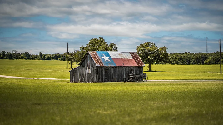 Pain Relief Spring TX Old Barn In A Field With A Texas Flag Roof